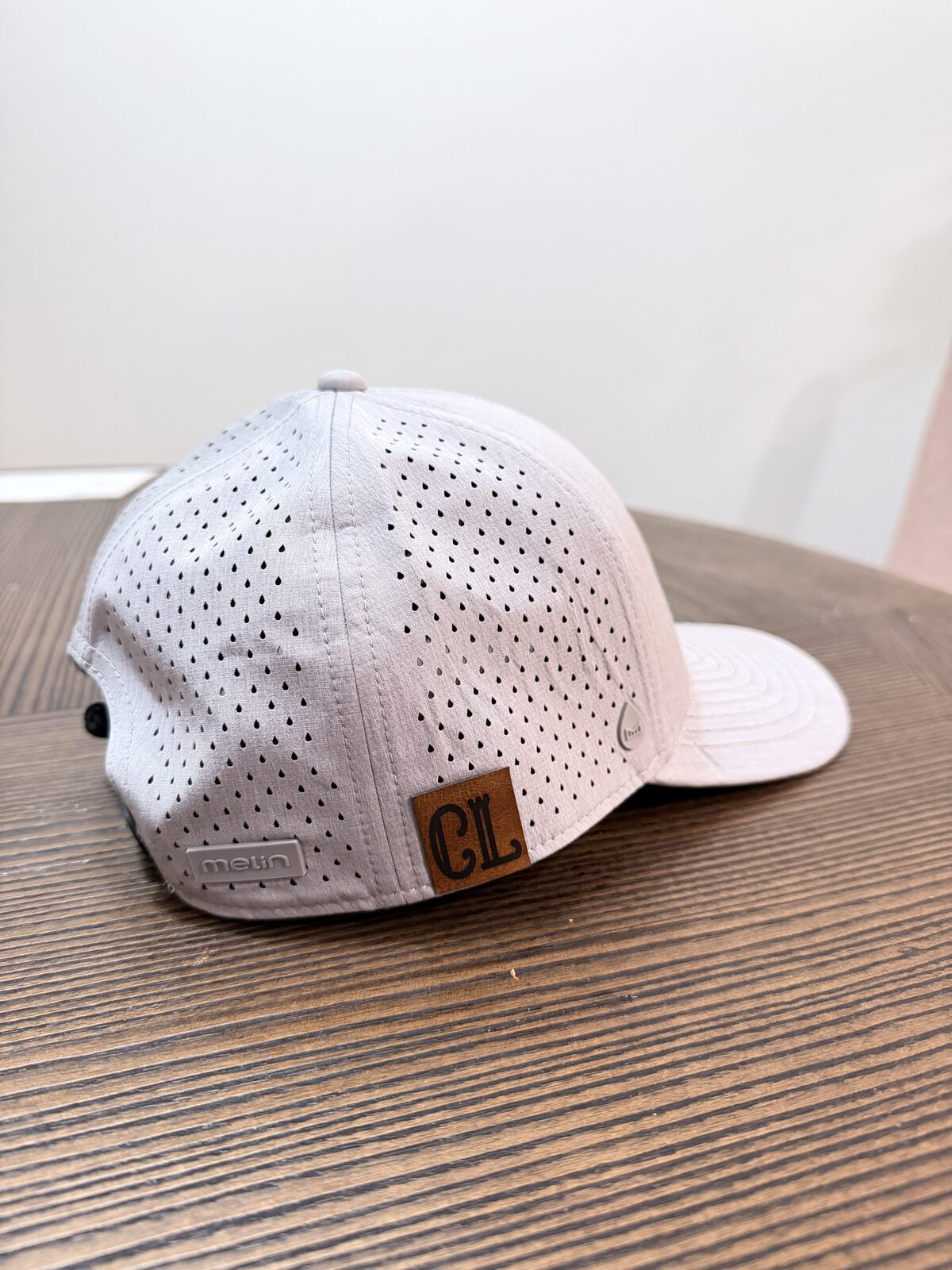 Custom cap with a leather-look patch freshly heat pressed at a hat bar