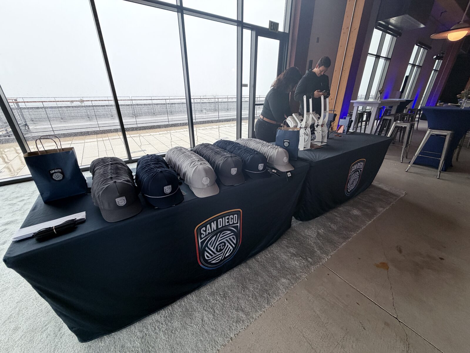 Finished custom caps displayed on a merch table at a hat bar event