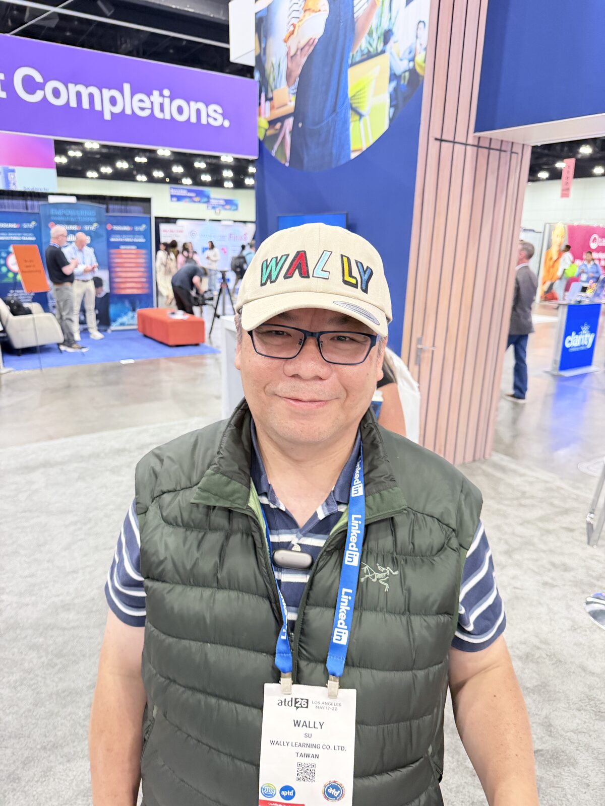 Guest holding a custom cap with a chenille patch made at a hat bar